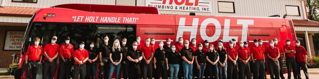 Holt Plumbing & Heating employees with bus "Let Holt Handle That"