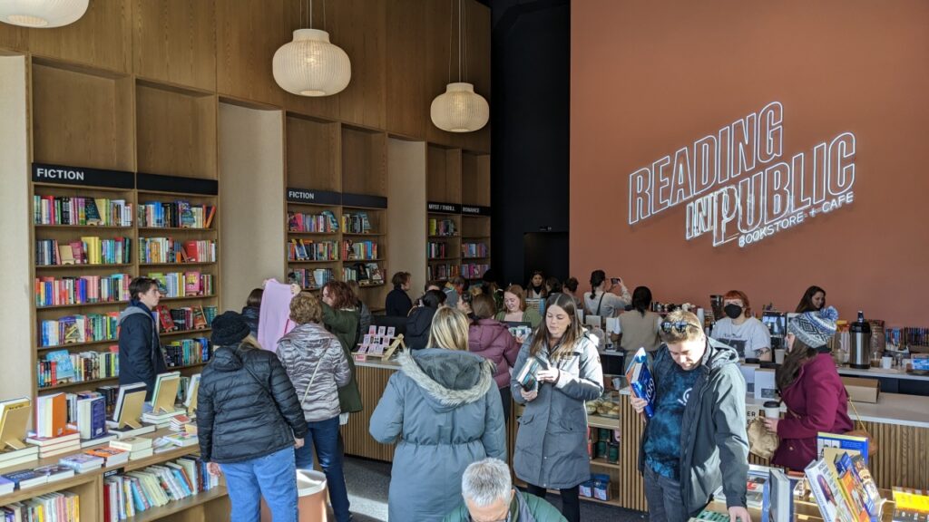 Reading in Public Bookstore + cafe people inside buying books